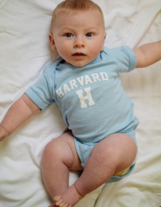 Baby in Harvard Onesie